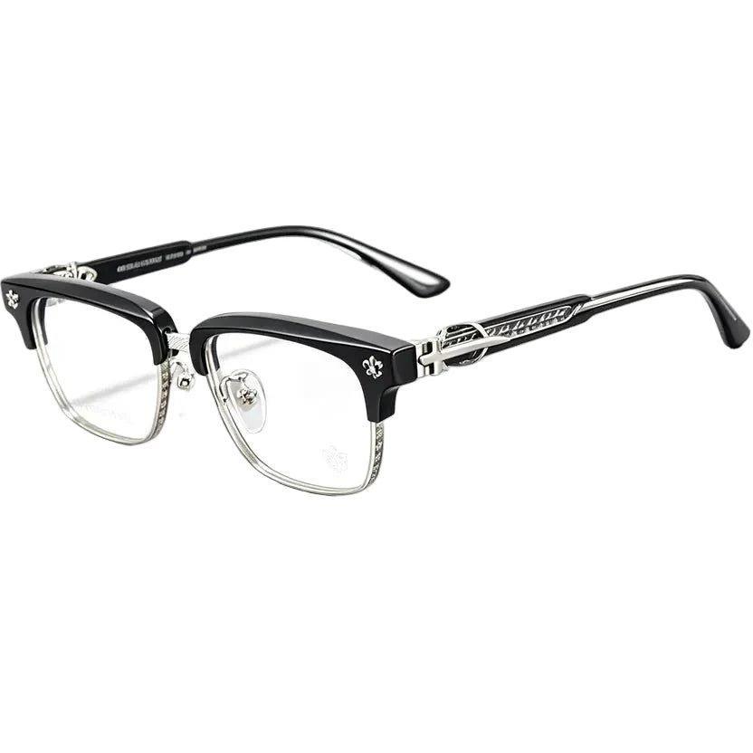 A pair of semi-rimless eyeglasses with a glossy black acetate upper frame and clear lower rims, featuring silver metal temples with decorative skull and crossbones details and the brand name 'Mister Loco' visible.