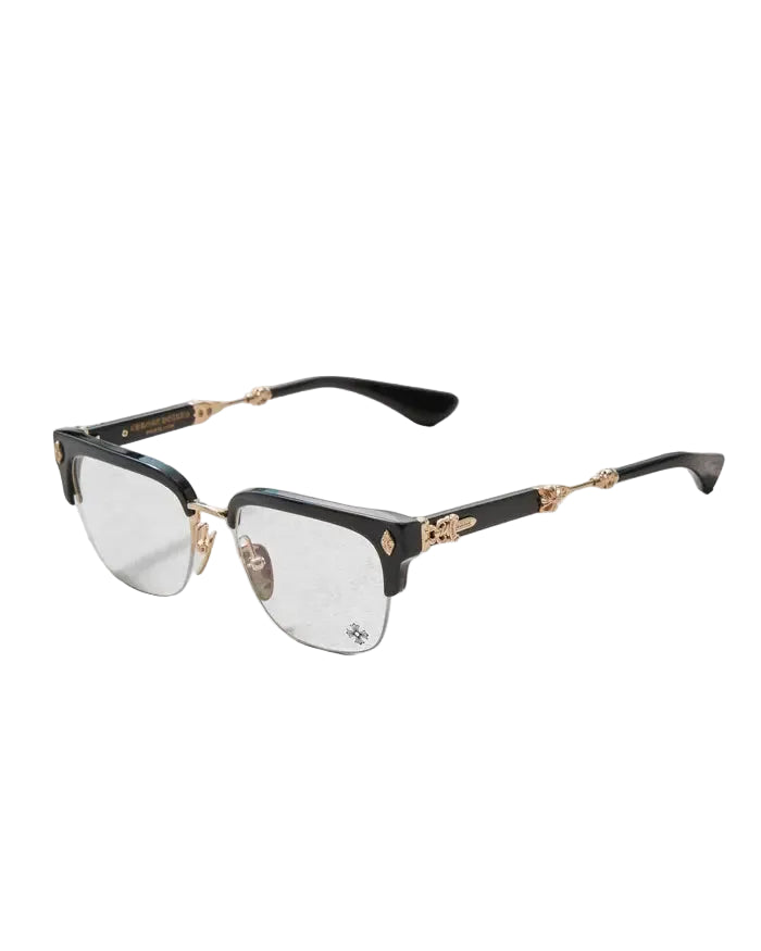 A pair of semi-rimless eyeglasses with a glossy black acetate frame, gold metal hinges, and clear lenses, displayed on a light gray textured surface.