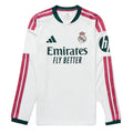 A white long-sleeve Real Madrid soccer jersey by Adidas, featuring dark green trim on the collar and cuffs, pink and white stripes on the sleeves, the Adidas logo on the right chest, the Real Madrid crest on the left chest, and the Emirates Fly Better sponsor logo across the center.