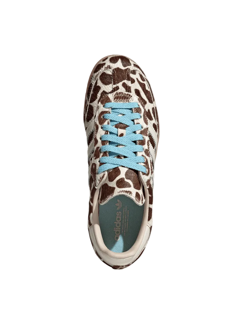 Sneaker with leopard print pattern and blue laces on a light gray background
