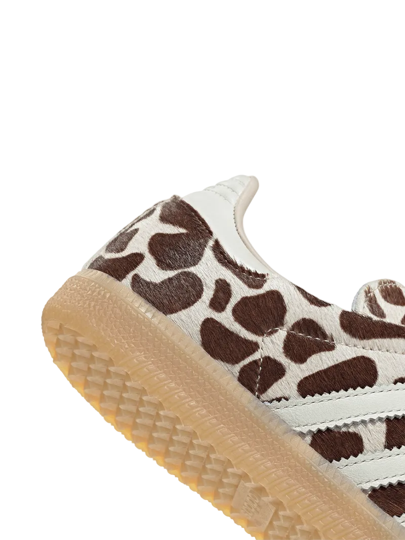 Close-up of a sneaker with brown and white pattern on a light gray background