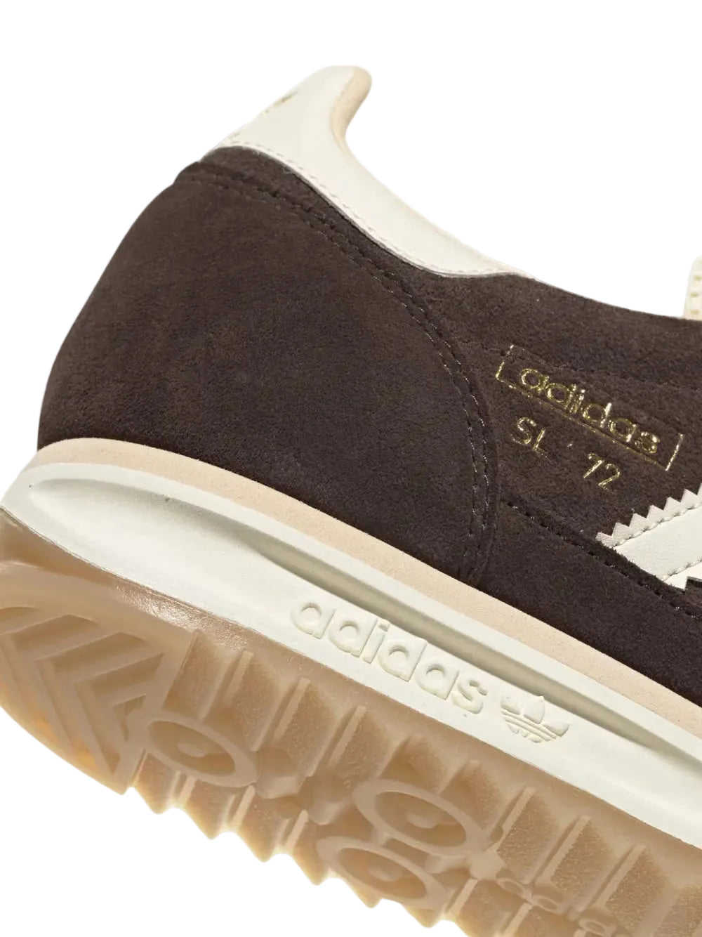 Close-up of an Adidas sneaker showing the dark brown suede upper, cream collar and midsole, and a gum sole.