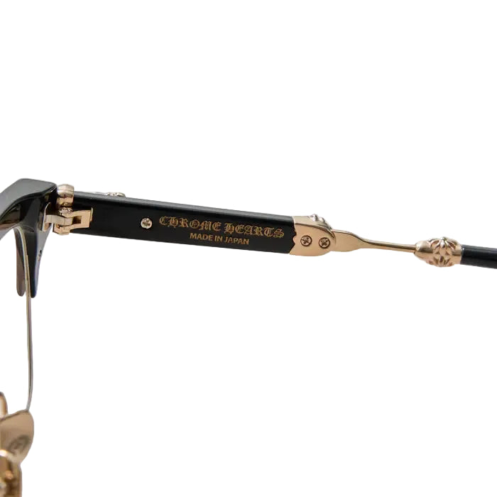 Close-up of a pair of eyeglass arms with black temples and gold metal hardware, including the brand name 'CHROME HEIRES' and 'MADE IN JAPAN' printed on the temple.