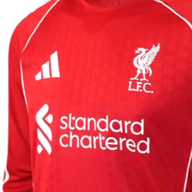 Close-up of a red long-sleeve soccer jersey with white trim, featuring the Adidas logo, Liverpool F.C.