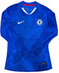 A blue long-sleeve Chelsea FC soccer jersey by Nike, featuring a subtle geometric pattern, a white Nike swoosh on the right chest, and the Chelsea club crest on the left chest.