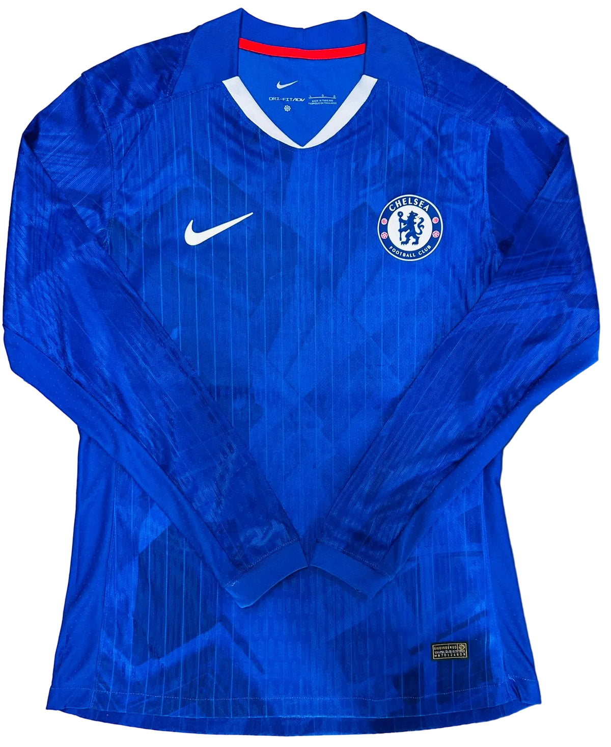 A blue long-sleeve Chelsea FC soccer jersey by Nike, featuring a subtle geometric pattern, a white Nike swoosh on the right chest, and the Chelsea club crest on the left chest.