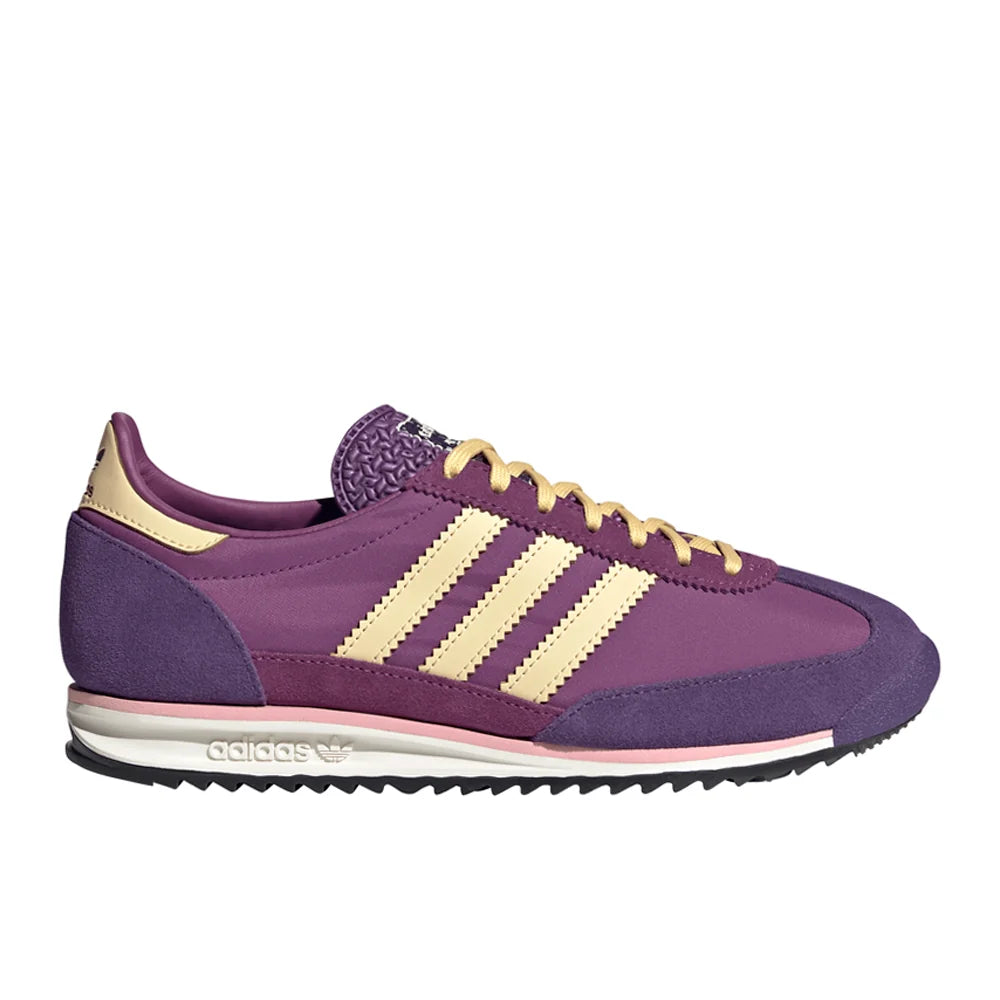 Purple Adidas sneaker with three white stripes on a white background