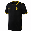 A black Nike Chelsea football jersey with yellow accents, featuring the Chelsea lion crest on the chest and a yellow Nike swoosh on the right chest.