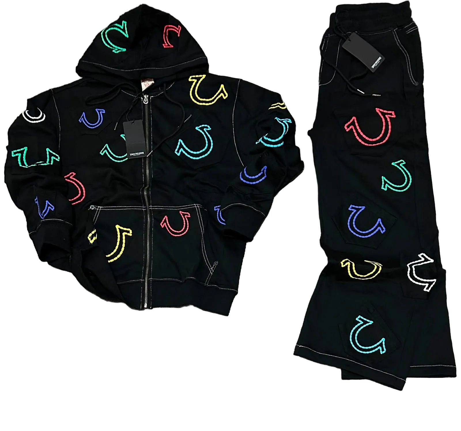A black zip-up hoodie and matching black pants laid flat on a gray textured surface. Both pieces feature colorful embroidered horseshoe motifs in multiple neon-like colors including green, blue, red, yellow, and white.