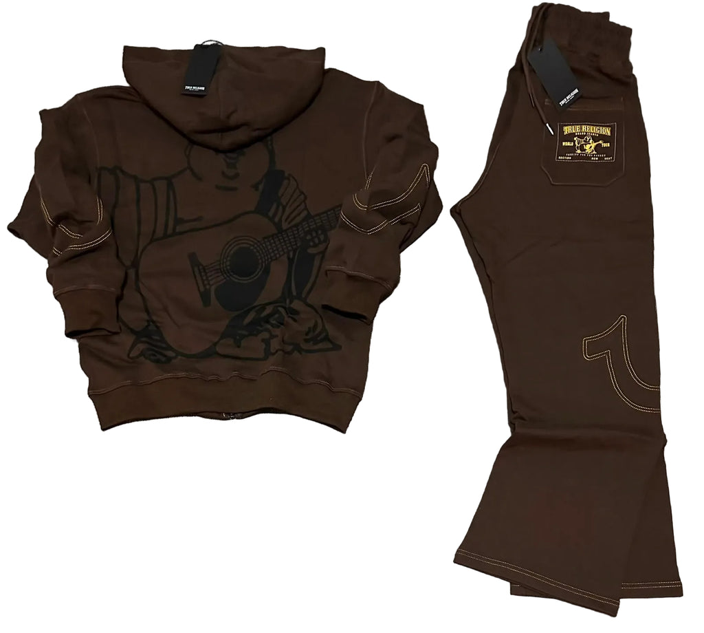 A dark brown two-piece tracksuit laid flat on a gray carpet background, consisting of a cropped zip-up hoodie with a guitar graphic and matching flared pants with contrast stitching and a brand patch.