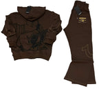 A dark brown two-piece tracksuit laid flat on a gray carpet background, consisting of a cropped zip-up hoodie with a guitar graphic and matching flared pants with contrast stitching and a brand patch.