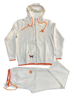 A white zip-up hoodie and matching sweatpants set laid flat on a dark gray textured background. The tracksuit features bright orange drawstrings, trim, and logo details, along with a small embroidered horse logo on the chest.
