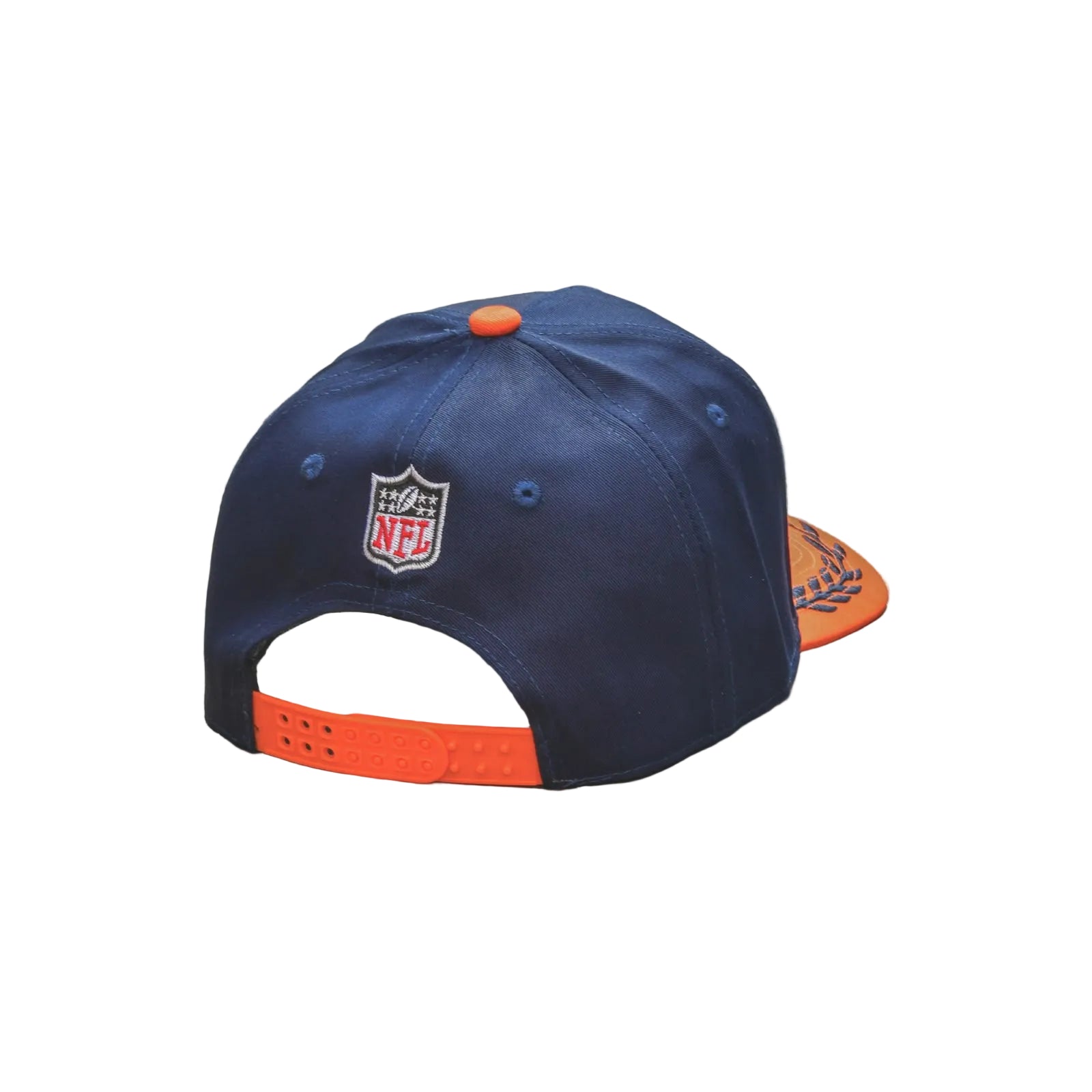 A navy blue NFL baseball cap with orange accents, including an orange back strap, orange snap button, and orange brim tip, resting on a weathered wooden table.
