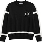A black knit sweater with white stripe accents on the shoulders, sleeves, and hem, featuring a white Loewe logo on the left chest and a Loewe label on the inner neck.