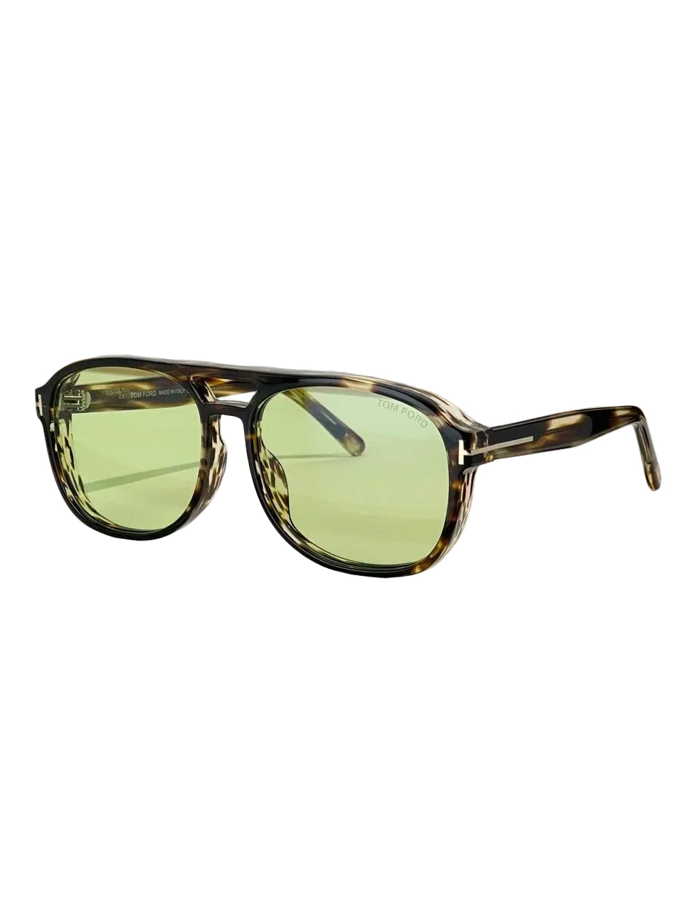 Tom Ford sunglasses with tortoiseshell frames and light green lenses, displayed on a wooden block with the brand box in the background.