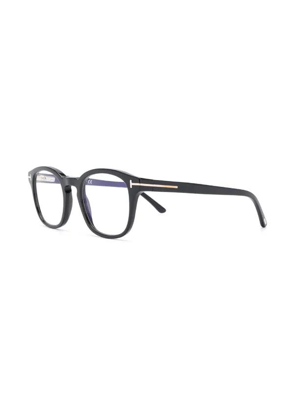 A pair of black acetate eyeglasses with a thin gold metal accent on the temple arm, shown from a side profile against a plain white background.