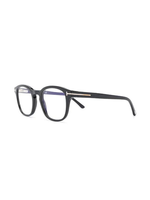 A pair of black acetate eyeglasses with a thin gold metal accent on the temple arm, shown from a side profile against a plain white background.