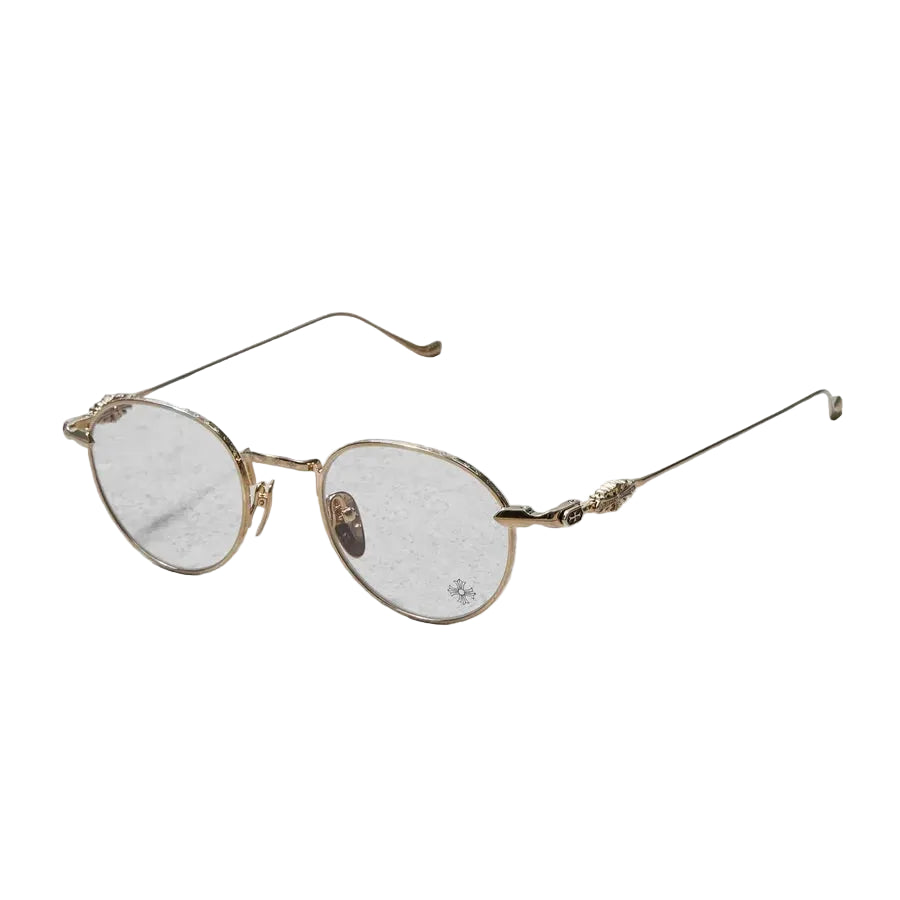 Gold-framed eyeglasses on a light gray textured background