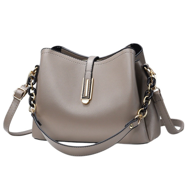 South Steeze gray shell-shaped crossbody bag in durable PU leather with an adjustable strap and decorative chain detail