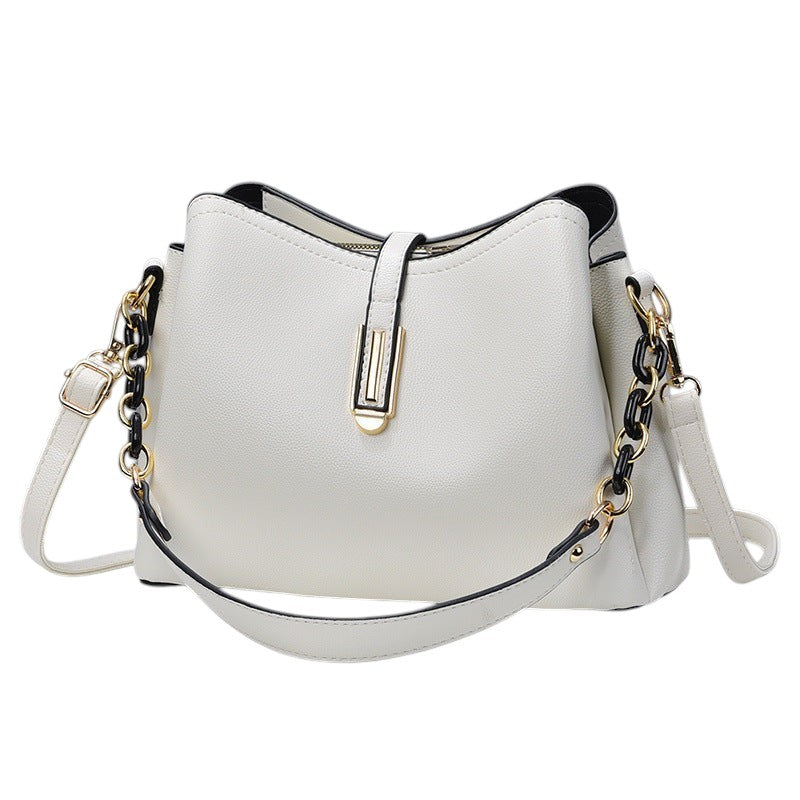 South Steeze off-white shell-shaped crossbody bag with a decorative chain strap and minimalist gold-tone hardware.