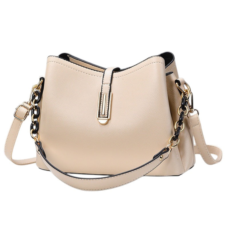 South Steeze off-white shell-shaped crossbody bag in durable PU leather with a decorative chain and adjustable strap.