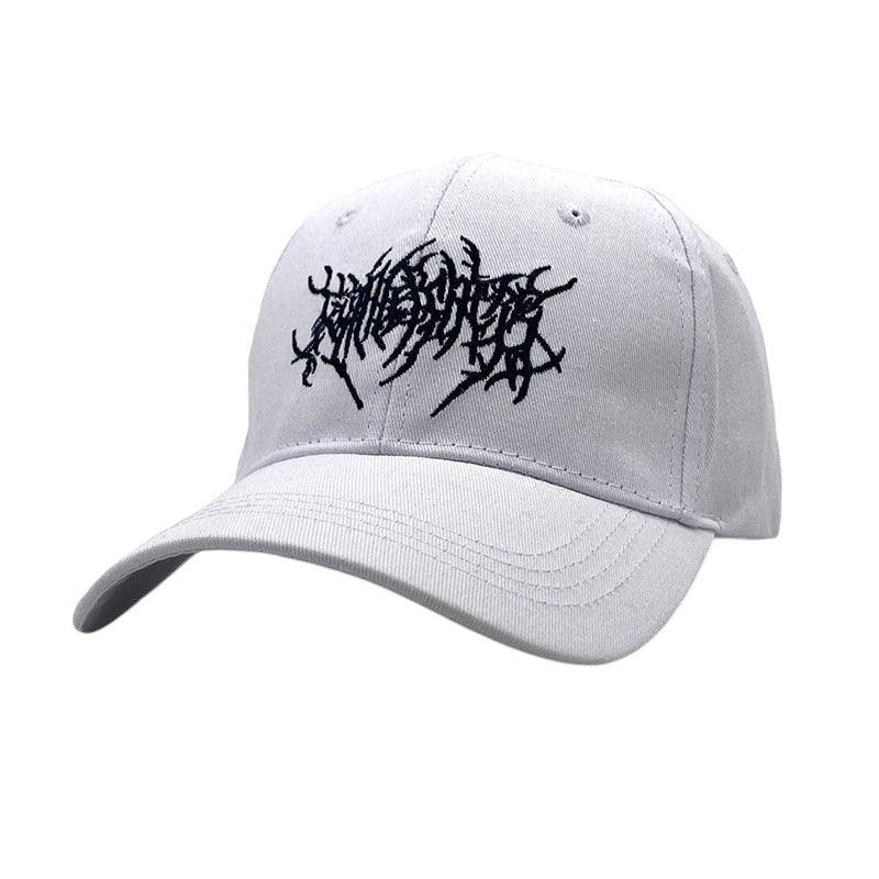 South Steeze white cotton baseball cap with intricate black metal-style embroidery on the front and curved brim.